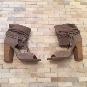 Grey peep toe booties with tie detail.